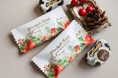 Luksusowe czekoladki świąteczne z grafiką poinsecji i złotymi akcentami, idealne na prezenty dla klientów.