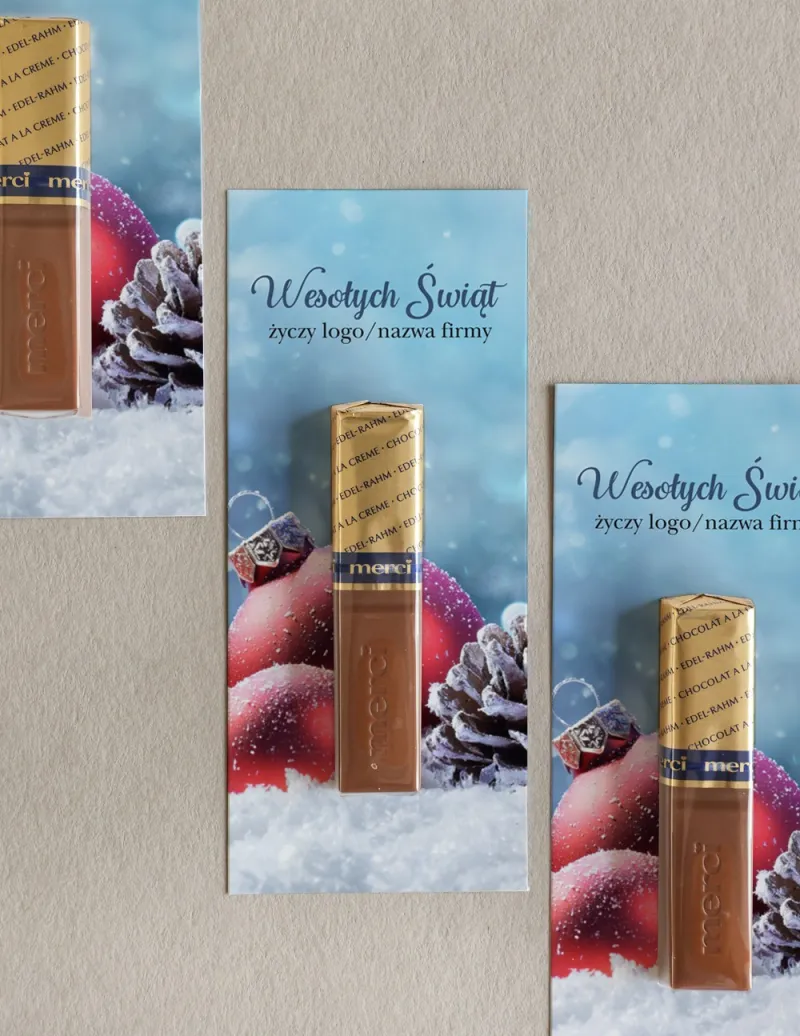 Firmowe czekoladki Merci z czerwonymi bombkami i śnieżynkami, idealne na świąteczne upominki dla klientów.