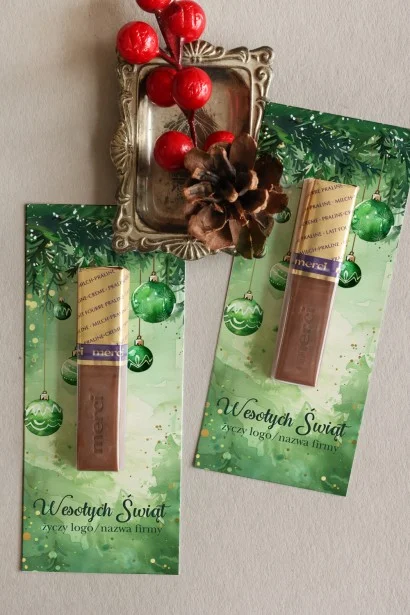 Firmowe czekoladki Merci z akwarelową grafiką choinek i zielonych bombek, idealne na świąteczne upominki.