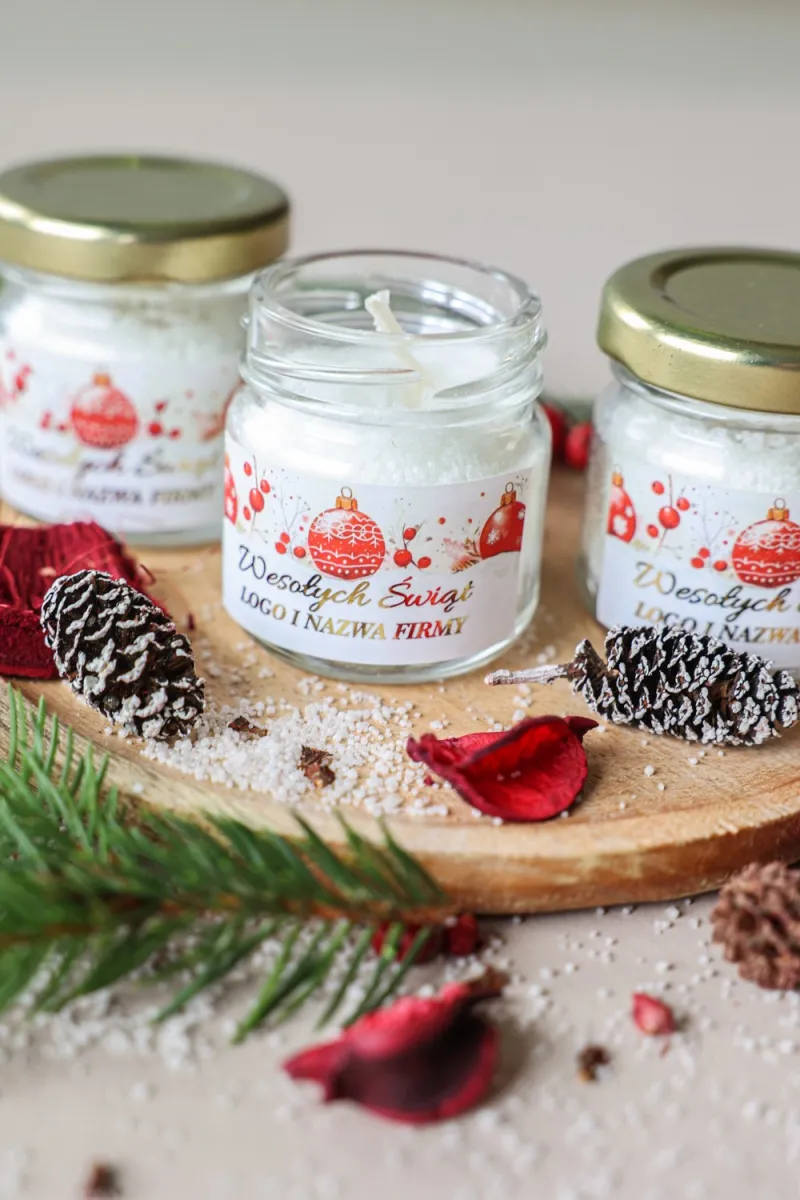 Świeczka w słoiczku z czerwoną bombką na świątecznej etykiecie, personalizowana na firmowe upominki Świeczka w słoiczku z czerwoną bombką na świątecznej etykiecie, personalizowana na firmowe upominki